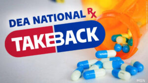 Logo for DEA National Rx Takeback over an open prescription bottle with white and blue capsule pills spilling out