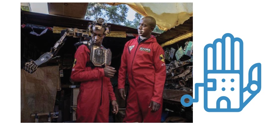 two men in red jumpsuits work on a robotic prosthetic arm